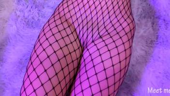 Asian in fishnet gives a footjob and gets cum all over her pussy